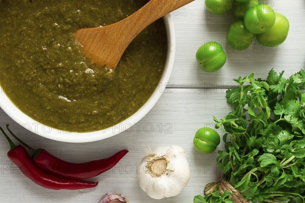 Tkemali sauce, traditional Georgian cuisine, green cherry plum, with ingredients for sauce,
