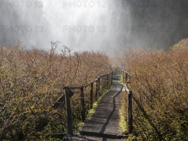 Waterfall Salto El Leon, path leading behind water veil, valley of waterfalls east of Pucon, La