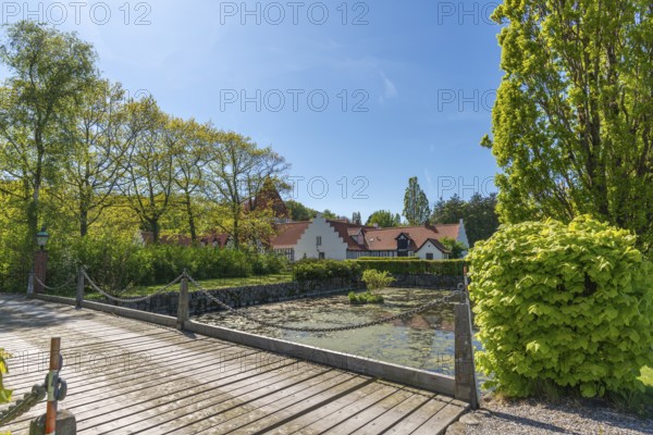 Risinge Herregaard, Ullerslev, Fyn manor house, moat, wooden bridge, trees, island of Funen,