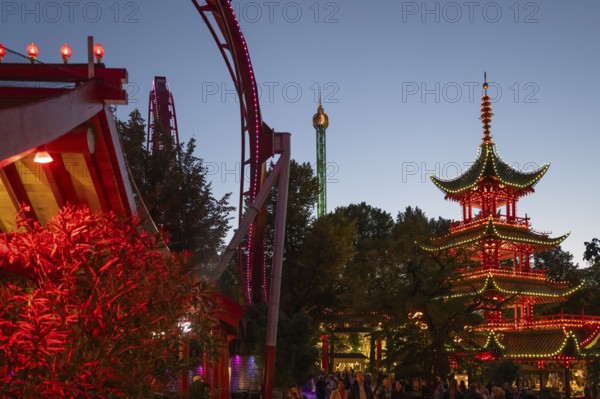 Red and yellow illuminated pagoda, roller coaster, Tivoli Amusement and Recreation Park,