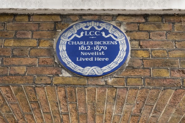 Blue plaque commemorating Charles Dickens on a brick wall, Charles Dickens Museum, 48-49 Doughty