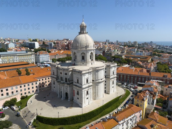 Central dome-shaped building in the foreground of a dense urban environment on a clear day,