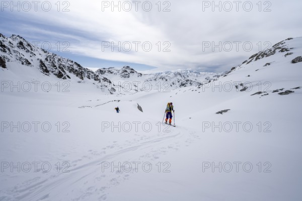 Ski tourer in mountain landscape with snow, ascent to Grialetsch Scharte, Bündner Haute Route,