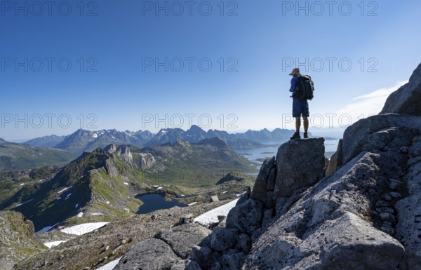View of mountains and fjord landscape, mountain panorama, mountaineer at the summit of Rundfjellet,