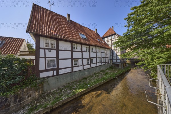 Half-timbered house against a cloudless blue sky on the Salze river in the city centre of Bad