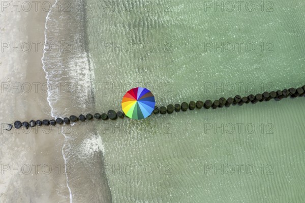 People with colorful umbrella on a groyne, beach of Baltic sea, aerial view, Mecklenburg-Western
