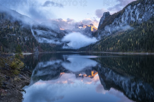 The Vordere Gosausee lake in autumn with a view of the Dachstein mountain range. The Gosaukamm on