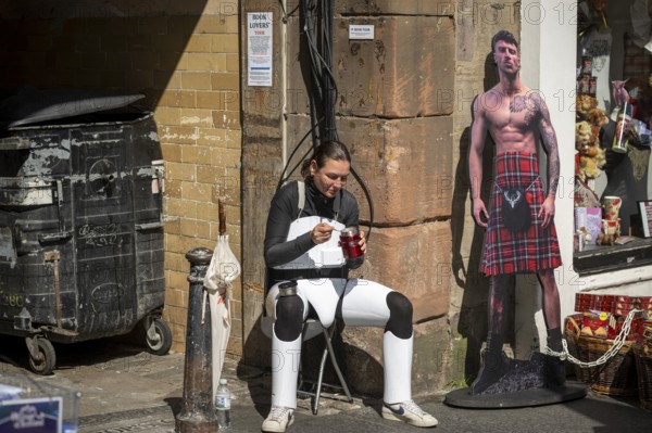 Participant taking a lunch break, world's largest cultural festival The Fringe, High Street,