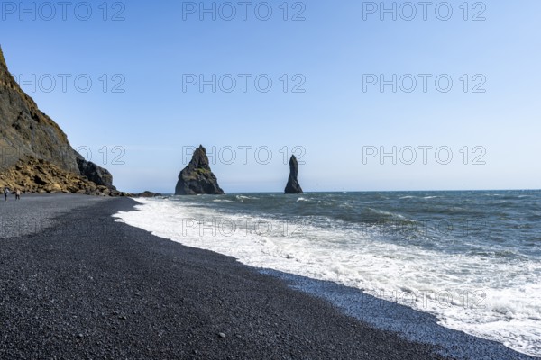 Black beach with cliffs, rock Reynisdrangar in the water, at Reynisfjara beach, Vik, South Iceland,