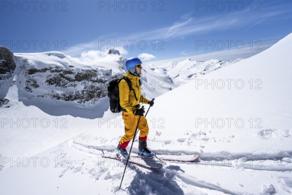 Ski tourer in mountain landscape with snow, ascent to Wildstrubelhütte, Bernese Alps, Switzerland,