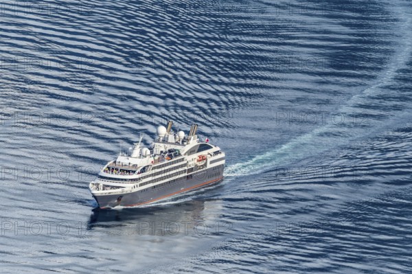 Cruise ship L'Austral leaving the Geirangerfjord into fjord Synnylvsfjord, seen from viewpoint at