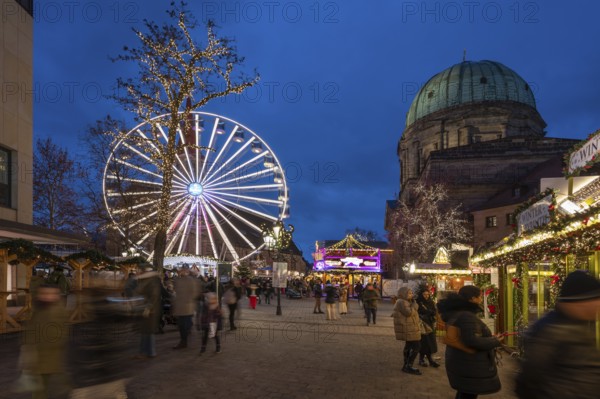 Ferris wheel at the winter village, Christmas market at dusk, St Elisabeth's Church on the right,