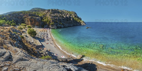Panoramic view of Ahata Beach with clear, turquoise-coloured sea and steep cliffs, Ahata Beach,