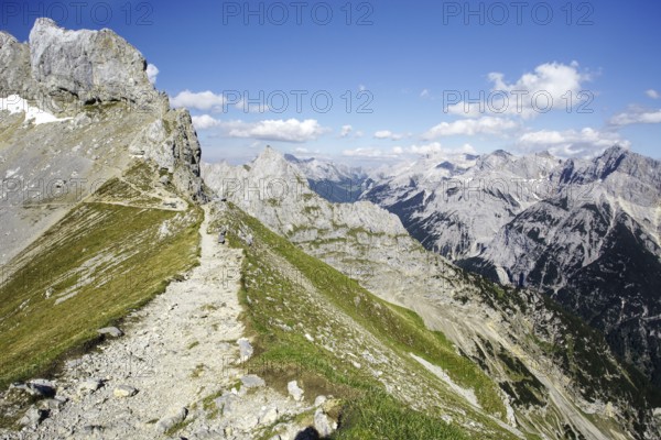 A hiking trail on a ridge with a view of a mountain landscape, Karwendel, Mittenwald, Bavaria,