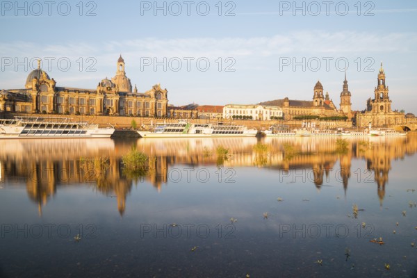 Silhouette of the Old Town with reflection in the Elbe in the morning, steamboats on the
