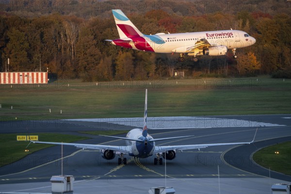 Eurowings Airbus A319-132, landing at Cologne-Bonn Airport, Sunexpress Boeing 737 waiting for