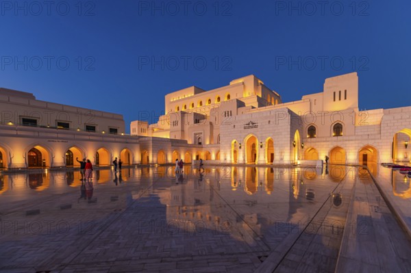 Visitors view the main square in front of the Royal Opera in the evening light, Muscat, Arabian