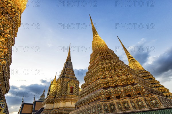 Wat Pho temple at sunset. Bangkok's oldest Buddhist monastery near the Grand Palace. Four chedis