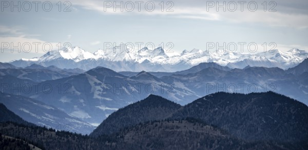 View of the Alpine foothills and main Alpine ridge with snow-covered peaks, summit of the Hohe