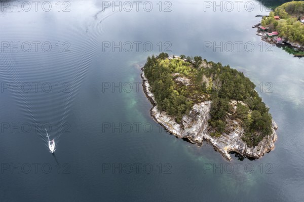 Aerial view topdown on island and sailing boat in the Lysefjord, just north of the Lysefjod bridge,