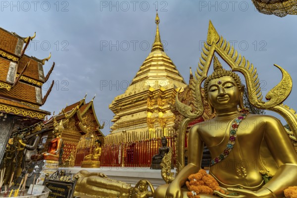 Buddha statue and Golden Chedi of the Buddhist temple complex Wat Phra That Doi Suthep, landmark of