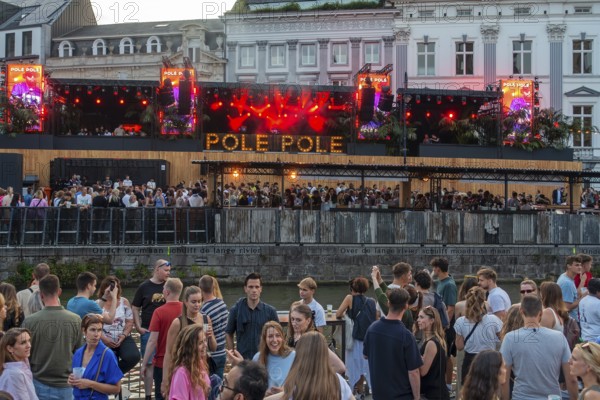 Spectators on grandstand at the Graslei watching Pole Pole podium during Gentse Feesten, Ghent city