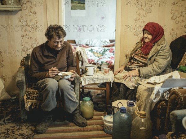 Varvara, 85, and her son Leonid, 56. Leonid looks after his mother, who is in need of care. She