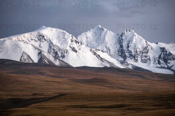 Glaciated and snow-capped mountains, dramatic landscape, high plateau, autumnal mountain landscape