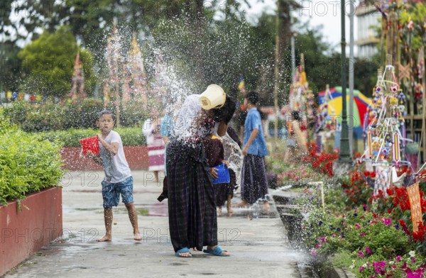 NAMSAI, INDIA.- APRIL 16: Devotees celebrate the vibrant Sangken Festival by pouring water over