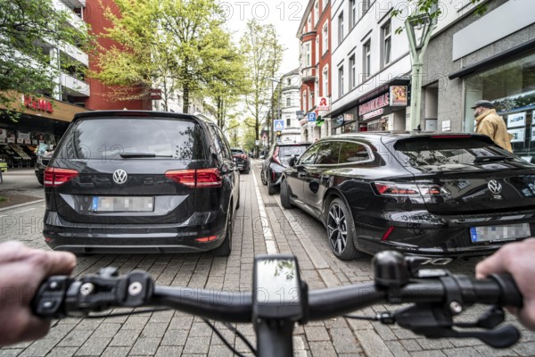 Cycling in the city, inner-city street, cycle lane, bicycles have priority, two-lane traffic with