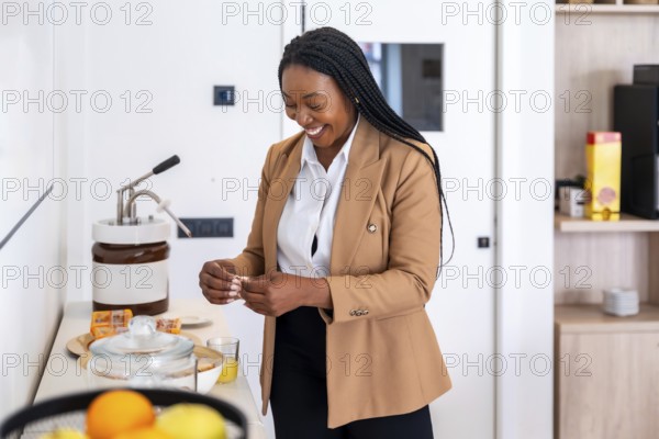 Smiling businesswoman preparing breakfast in hotel room during business trip, enjoying amenities