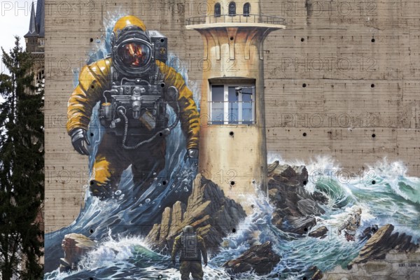 Astronaut standing in surf, mural on the subject of climate change on a bunker, by street art