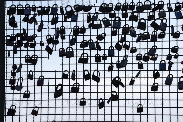 Padlocks, so-called love locks on a fence, vantage point in Wesel am Rhein, North Rhine-Westphalia,