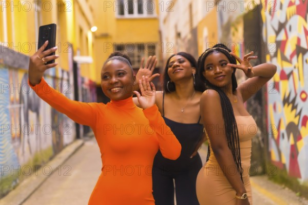 San Sebastián, Gipuzkoa Spain, February 2021: Three girls taking a selfie. Fashionable urban style