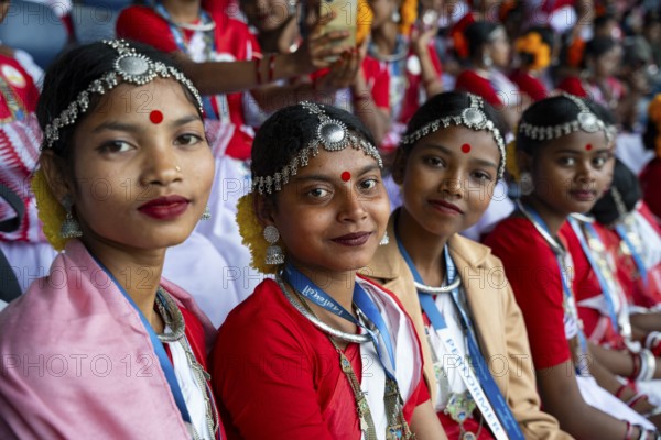 Girls from tea tribe community wearing traditional attire, wait to perform traditional Jhumur
