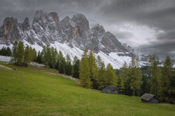View of a part of the Geisler group in the foreground two mountain huts, Dolomites, snow,