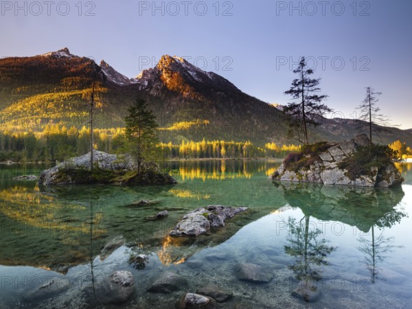 Hintersee in the morning in the first sunlight, behind the peaks of the Hochkalter, Berchtesgaden