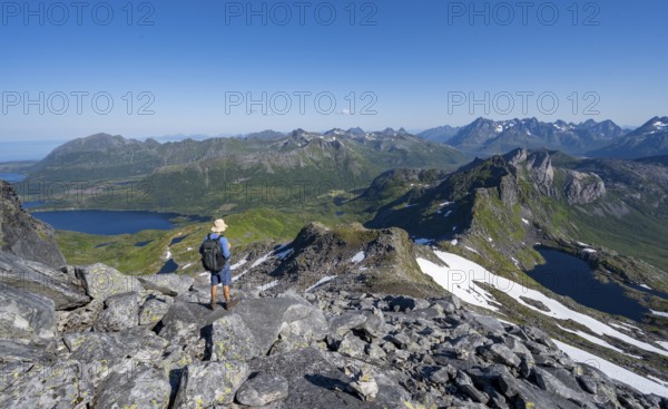 View of mountains and fjord landscape, mountain panorama, mountaineer at the summit of Rundfjellet,