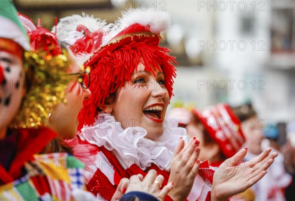 Colourfully costumed carnivalists celebrate carnival in Cologne, on Weiberfastnacht the street