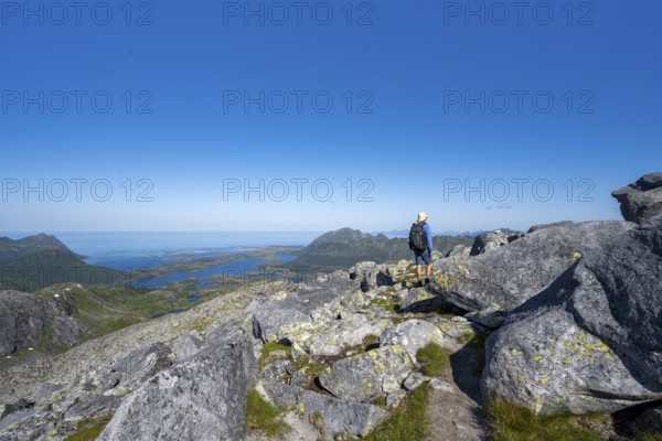 View of mountains and fjord landscape, mountain panorama, mountaineer at the summit of Rundfjellet,