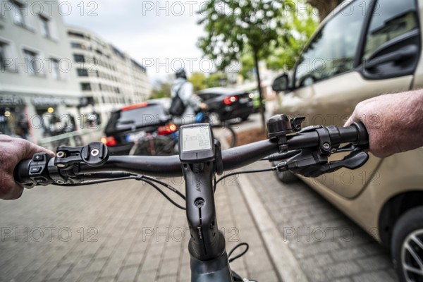 Cycling in the city, inner-city street, cycle lane, bicycles have priority, two-lane traffic with