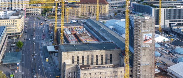 Stuttgart main station with Bonatzbau. Stuttgart 21 construction site with station tower and crane.