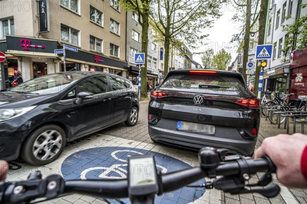 Cycling in the city, inner-city street, cycle lane, bicycles have priority, two-lane traffic with
