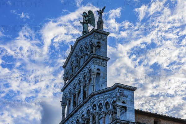 Facade of the church of San Michele in Foro, above the large bronze statue of the Archangel