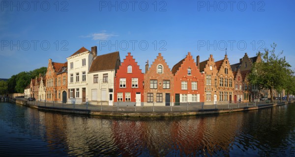 Typical Belgian cityscape Europe tourism concept, panorama of canal and old houses on sunset.