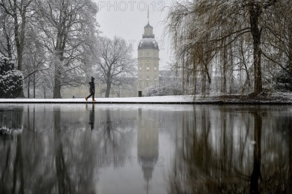 Karlsruhe castle reflected in a pond in the castle garden, Karlsruhe, Baden-Württemberg, Germany,