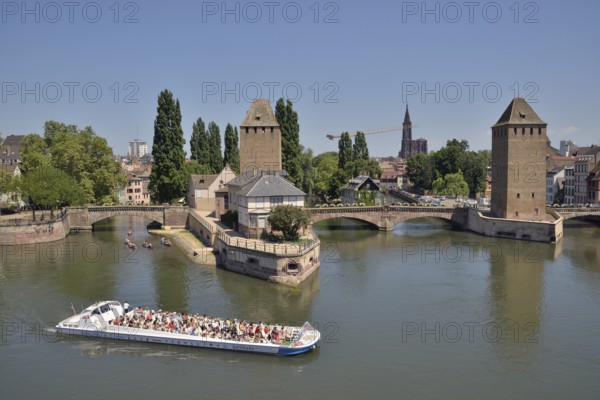 Excursion boat on the River Ill at the Ponts Couverts bridge with towers, UNESCO World Heritage