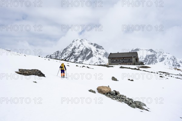 Ski tourer in the mountains in winter, Piz Bever, Chamanna Jenatsch CAS, Swiss Alpine Club hut, Val