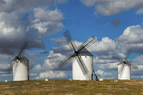 Three windmills in front of a dramatic sky with imposing clouds, Campo de Criptana, Ciudad Real