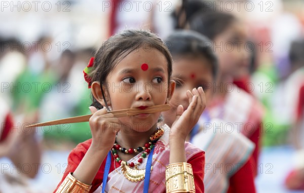 A girl plays Gagana (musical instrument) as she participate in a Bihu dance workshop, ahead of